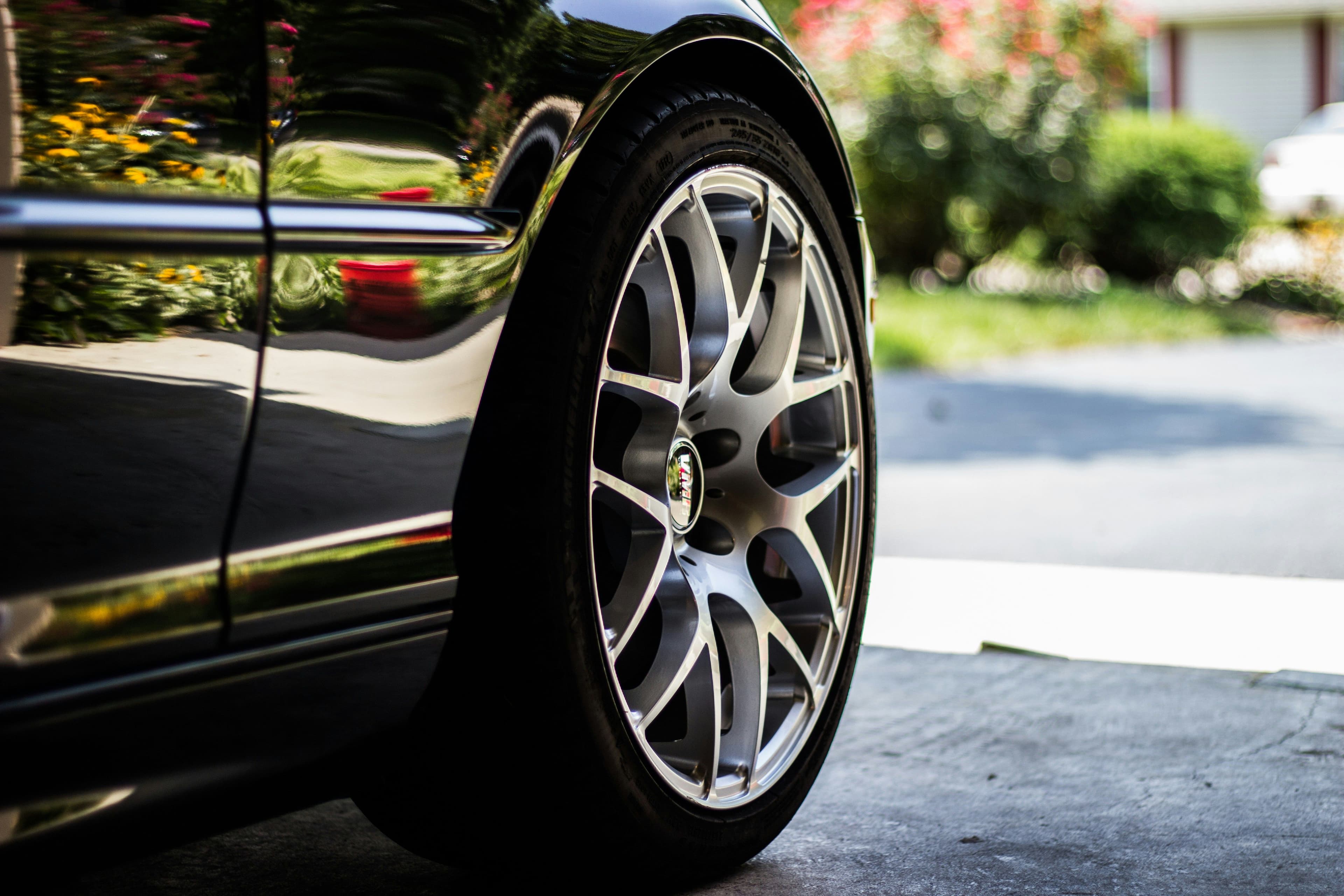 a close up of a car wheel on a driveway